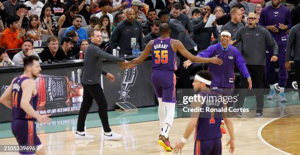 Kevin Durant of the Phoenix Suns is congratulated by head coach Frank Vogel and Isiah Thomas after a three-pointer against the San Antonio Spurs in...