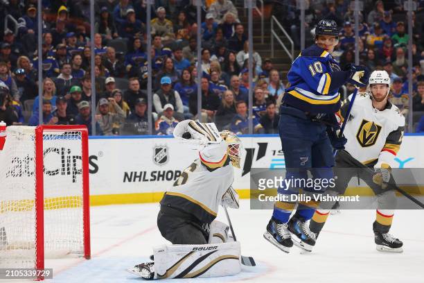 Logan Thompson of the Vegas Golden Knights makes a save against Brayden Schenn of the St. Louis Blues during the third period at Enterprise Center on...