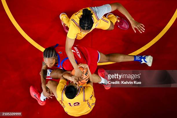 JuJu Watkins of the USC Trojans steals the ball from Taiyanna Jackson of the Kansas Jayhawks as Rayah Marshall of the USC Trojans watches during the...