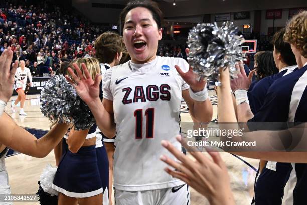 Kayleigh Truong of the Gonzaga Bulldogs celebrates with Gonzaga Bulldogs cheerleaders after the win over the Utah Utes during the second round of the...
