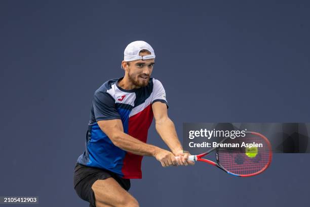 Tomas Macha of the Czech Republic hits a shot against Andrey Rublev during their match on day 7 of the Miami Open at Hard Rock Stadium on March 22,...