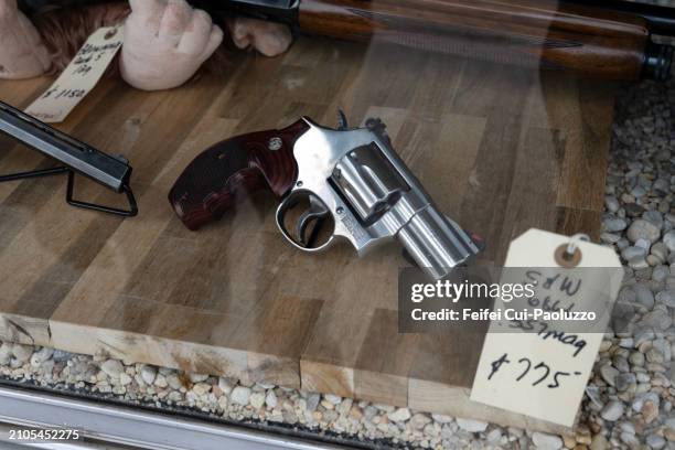 pistol for sale in a gun store - handgun stock pictures, royalty-free photos & images