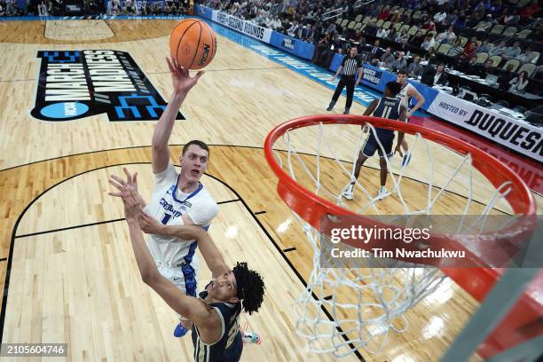 Ryan Kalkbrenner of the Creighton Bluejays shoots over Enrique Freeman of the Akron Zips in the first round of the NCAA Men's Basketball Tournament...