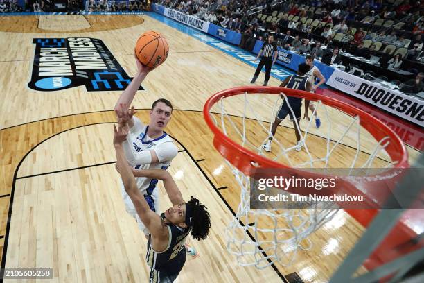 Ryan Kalkbrenner of the Creighton Bluejays shoots over Enrique Freeman of the Akron Zips in the first round of the NCAA Men's Basketball Tournament...