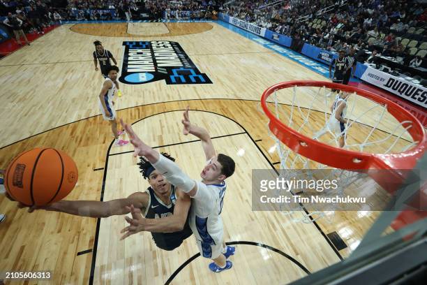 Enrique Freeman of the Akron Zips shoots a lay up past Ryan Kalkbrenner of the Creighton Bluejays in the first round of the NCAA Men's Basketball...