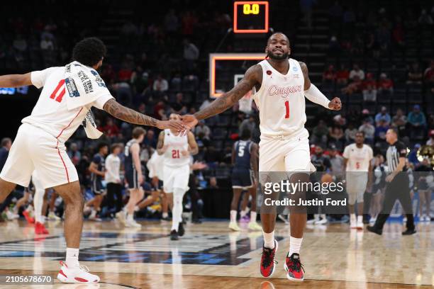 Jamal Shead of the Houston Cougars is congratulated by Damian Dunn during the second half against the Longwood Lancers in the first round of the NCAA...