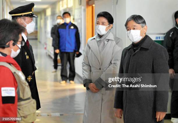 Emperor Naruhito and Empress Masako talk with volunteers, police officers and fire company chief after the Noto Peninsula Earthquakes on March 22,...