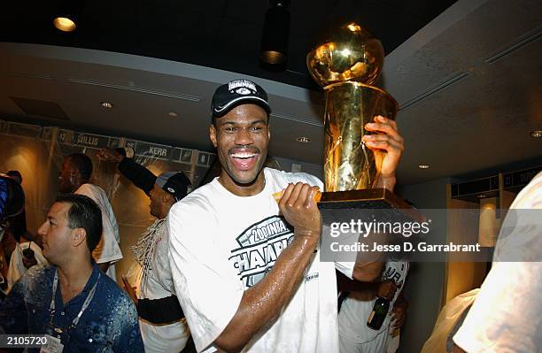 David Robinson of the San Antonio Spurs poses with the NBA Championship trophy in Game six of the 2003 NBA Finals against the New Jersey Nets at SBC...