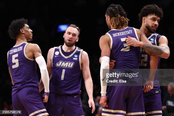 Terrence Edwards Jr. #5 of the James Madison Dukes celebrates with teammates after defeating the Wisconsin Badgers 72-61 in the first round of the...