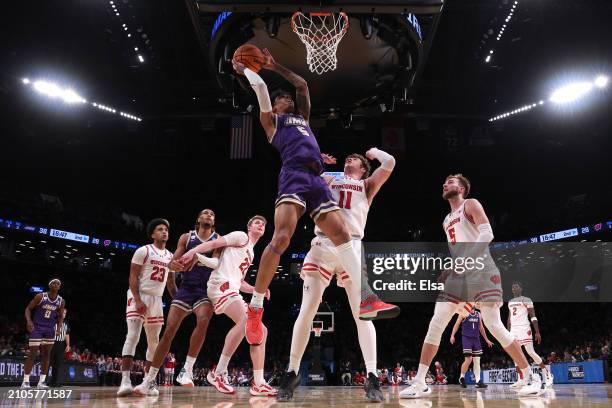 Terrence Edwards Jr. #5 of the James Madison Dukes shoots the ball against Max Klesmit of the Wisconsin Badgers during the second half in the first...