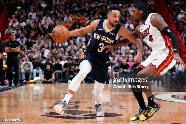 McCollum of the New Orleans Pelicans dribbles the ball against Delon Wright of the Miami Heat during the third quarter at Kaseya Center on March 22,...