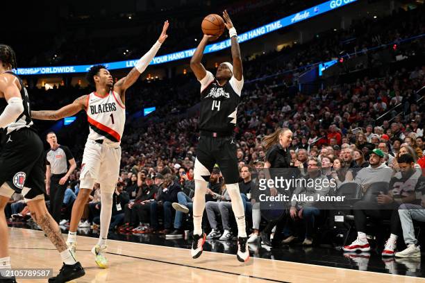 Terance Mann of the LA Clippers shoots a three point basket against Anfernee Simons of the Portland Trail Blazers during the second quarter of the...