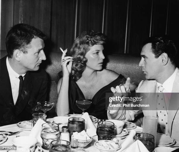 American songwriter and actor Bobby Troup , his wife: American singer and actor Julie London and american musician Ray Anthony sit at a table at the...
