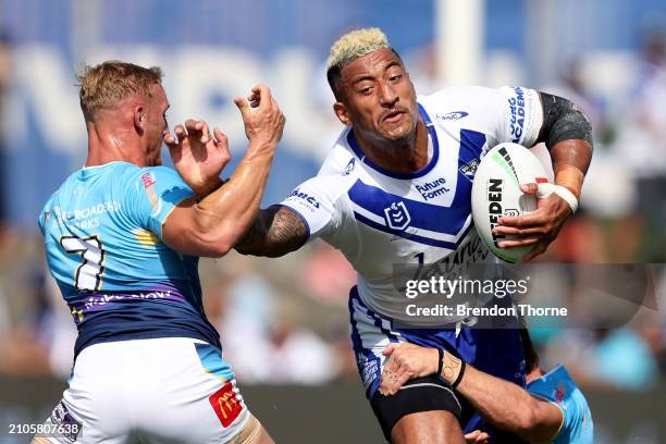 Viliame Kikau of the Bulldogs fends off Tanah Boyd of the Titans during the round three NRL match between Canterbury Bulldogs and Gold Coast Titans...