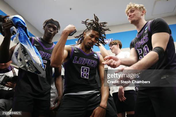 Lok Wur, Collin Moore, and Duke Brennan of the Grand Canyon Antelopes celebrate in the locker room with teammates after their victory against the St....
