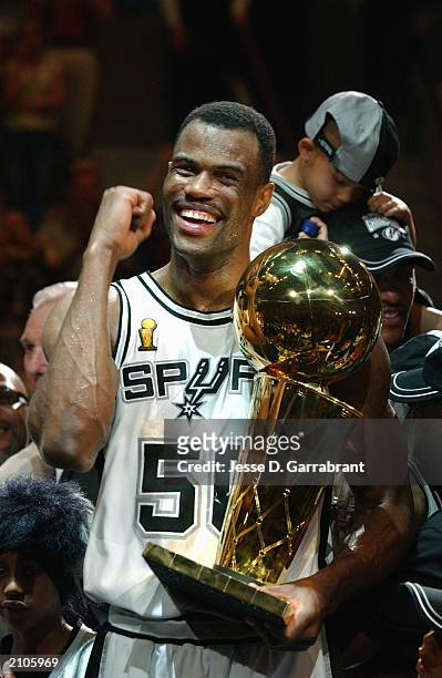 David Robinson of the San Antonio Spurs celebrates with the NBA Championship trophy after Game six of the 2003 NBA Finals against the New Jersey Nets...