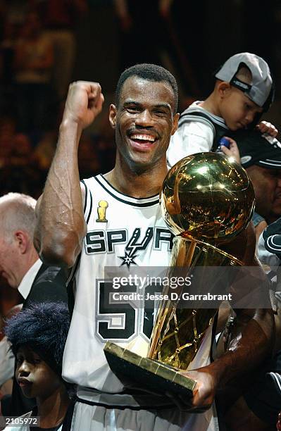 David Robinson of the San Antonio Spurs celebrates with the NBA Championship trophy after Game six of the 2003 NBA Finals against the New Jersey Nets...