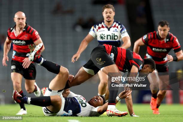 Chay Fihaki of the Crusaders is tackled by Caleb Clarke of the Blues during the round five Super Rugby Pacific match between Blues and Crusaders at...