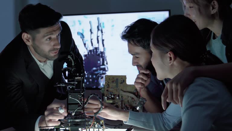 Test Development Arm Team of Inventor Engineer Assembling and Testing Robot Arm in a ...