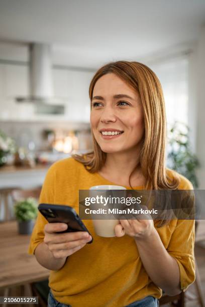 a young woman enjoys a quiet morning in her apartment - moment of silence stock pictures, royalty-free photos & images