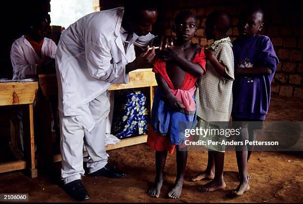 School children get vaccinated against measles through a program sponsored by UNICEF February 13, 2003 in Gotovo, Rwanda. Gotovo is one of many small...