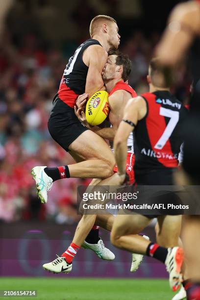 Harry Cunningham of the Swans is challenged by Peter Wright of the Bombers during the round two AFL match between Sydney Swans and Essendon Bombers...