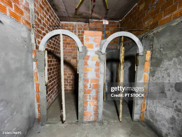 construction work on the room using bricks and mortar has not yet been completed. - unfinished basement stock pictures, royalty-free photos & images
