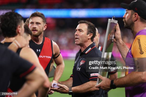 Bombers head coach Brad Scott speaks to players at three quarter time during the round two AFL match between Sydney Swans and Essendon Bombers at...