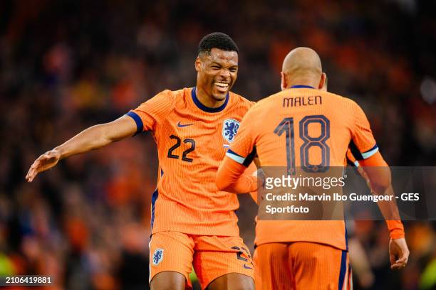 Donyell Malen of the Netherlands celebrates with Denzel Domfries his team's fourth goal during the friendly match between Netherlands and Scotland at...