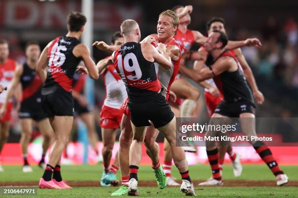 Isaac Heeney of the Swans wrestles with Nick Hind of the Bombers during the round two AFL match between Sydney Swans and Essendon Bombers at SCG, on...