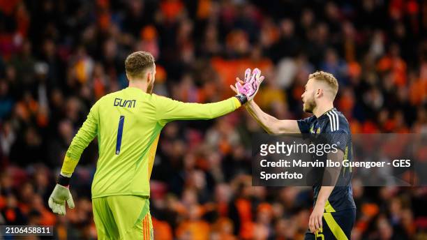 Angus Gunn shake hands with Ryan Porteous of Scotland during the friendly match between Netherlands and Scotland at Johan Cruyff Arena on March 22,...