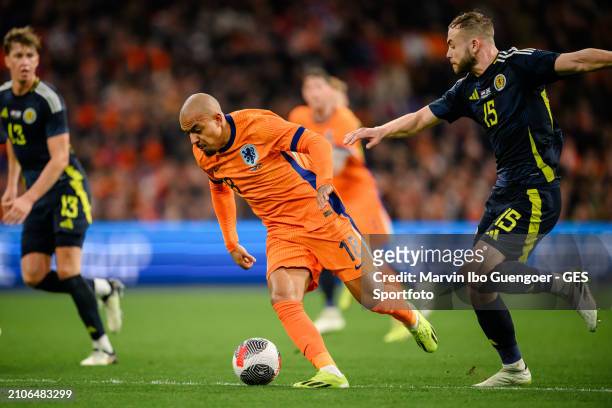 Donyell Malen of the Netherlands is tackled by Ryan Porteous of Scotland during the friendly match between Netherlands and Scotland at Johan Cruyff...