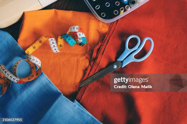 various type of sewing tools on the vibrant linen textile - sewing stock pictures, royalty-free photos & images