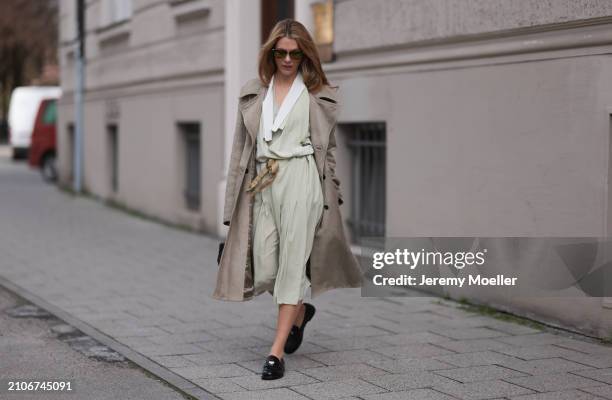 Viviane Geppert seen wearing Miu Miu gold / black sunglasses, Miu Miu pastel green flattered midi dress, Miu Miu beige / brown trenchcoat / long...