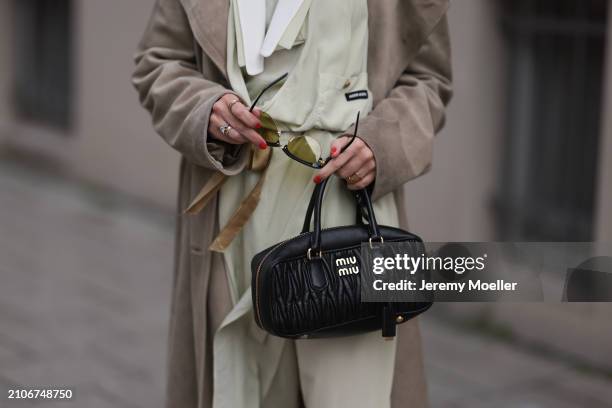 Viviane Geppert seen wearing Miu Miu gold / black sunglasses, Miu Miu pastel green flattered midi dress, Miu Miu beige / brown trenchcoat / long coat...