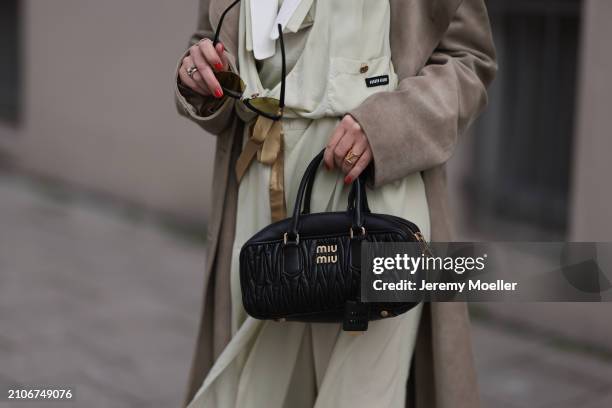 Viviane Geppert seen wearing Miu Miu gold / black sunglasses, Miu Miu pastel green flattered midi dress, Miu Miu beige / brown trenchcoat / long coat...