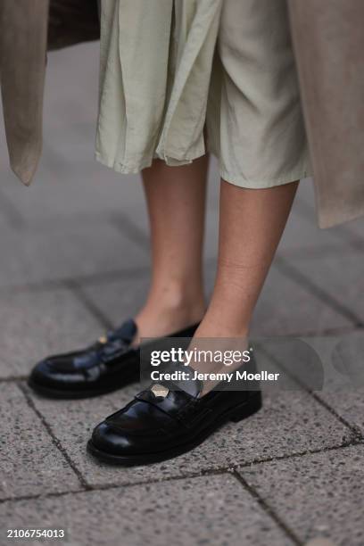 Viviane Geppert seen wearing Miu Miu shiny black loafers, on March 22, 2024 in Munich, Germany.