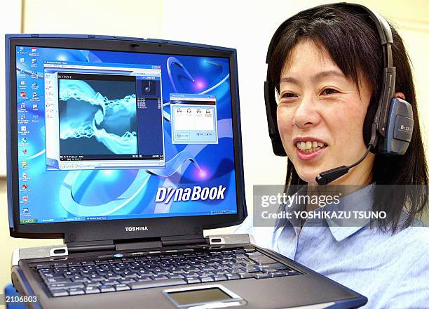 Japan's electronics giant Toshiba employee Junko Furuta displays the company's latest notebook computer "Dynabook G8" equipped with 2GHz-Mobile...