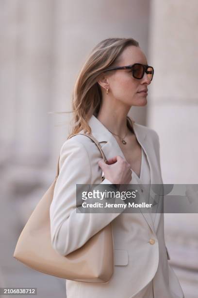 Marlies Pia Pfeifhofer seen wearing Vehla Eyewear brown sunglasses, gold necklace and earrings, Cinque creamy white suit vest, Cinque creamy white...
