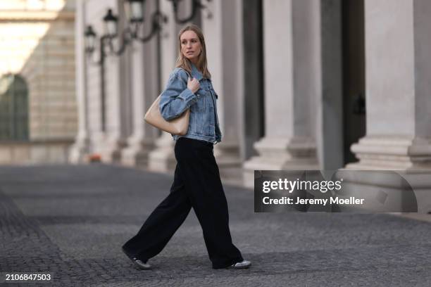 Marlies Pia Pfeifhofer seen wearing gold necklace and earrings, Agolde light blue denim short jeans jacket, Agolde black denim wide leg jeans pants,...