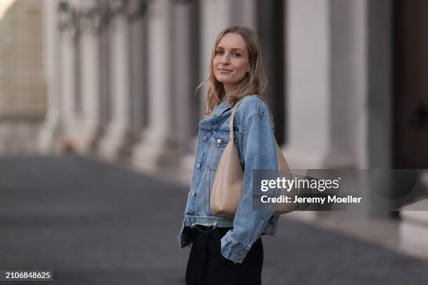 Marlies Pia Pfeifhofer seen wearing gold earrings, Agolde light blue denim short jeans jacket, Agolde black denim wide leg jeans pants and By Far...