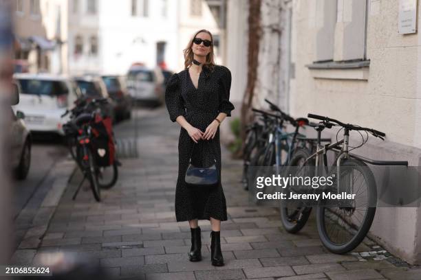 Marlies Pia Pfeifhofer seen wearing Ray-Ban black Wayfarer sunglasses, gold necklace and earrings, Adoore black with white dotty print pattern v-neck...