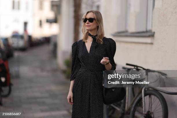 Marlies Pia Pfeifhofer seen wearing Ray-Ban black Wayfarer sunglasses, gold necklace and earrings, Adoore black with white dotty print pattern v-neck...