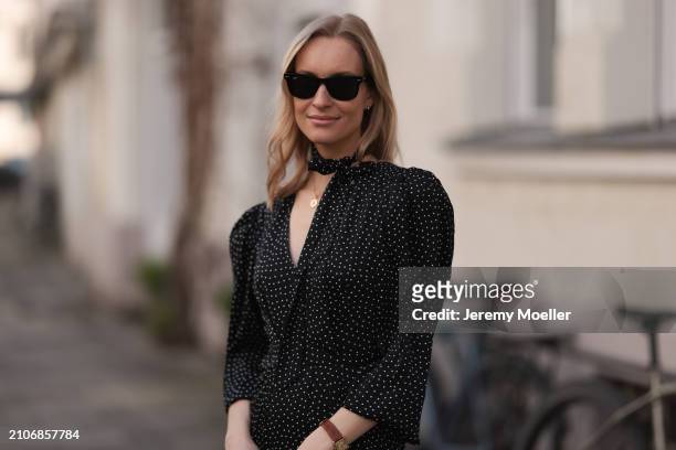 Marlies Pia Pfeifhofer seen wearing Ray-Ban black Wayfarer sunglasses, gold necklace and silver earrings, Adoore black with white dotty print pattern...