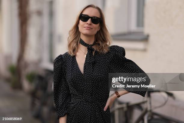 Marlies Pia Pfeifhofer seen wearing Ray-Ban black Wayfarer sunglasses, gold necklace and silverearrings, Adoore black with white dotty print pattern...