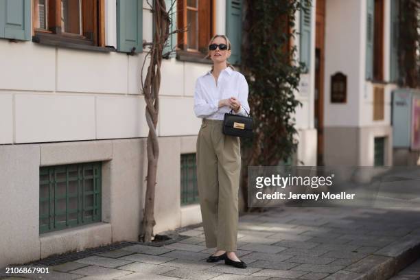 Marlies Pia Pfeifhofer seen wearing Versace black sunglasses, gold earrings and necklace, LaMarel white cotton buttoned blouse shirt, Agolde beige...