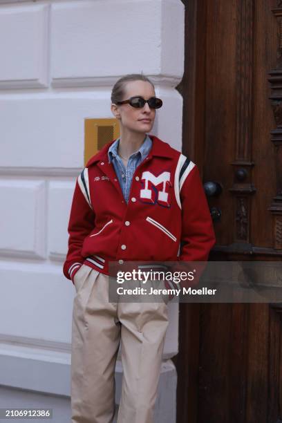 Marlies Pia Pfeifhofer seen wearing brown oval sunglasses, gold necklace, Citizen of Humanity light blue denim blouse / buttoned shirt, Mother red...