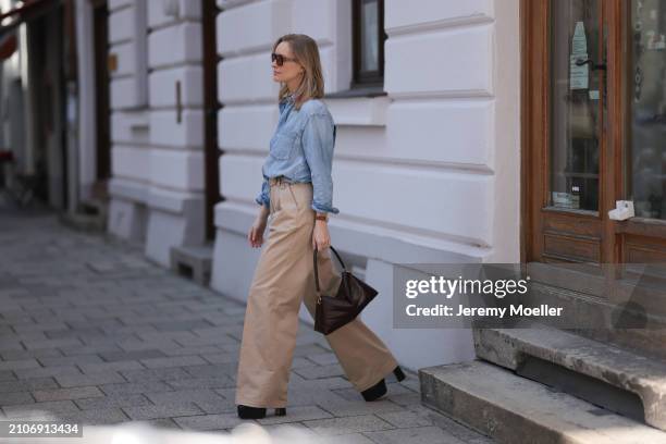 Marlies Pia Pfeifhofer seen wearing Vehla Eyewear brown sunglasses, gold necklace, Citizen of Humanity light blue denim blouse / buttoned shirt,...