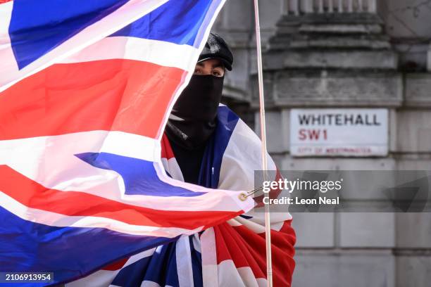 Man wears a facemask and Union Flag during a Right-wing "Rally for British Culture" near to The Cenotaph on March 23, 2024 in London, England. The...
