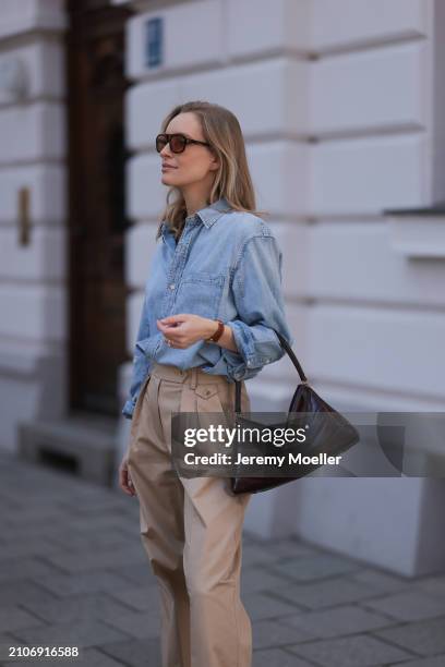 Marlies Pia Pfeifhofer seen wearing Vehla Eyewear brown sunglasses, Citizen of Humanity light blue denim blouse / buttoned shirt, Andiata beige wide...